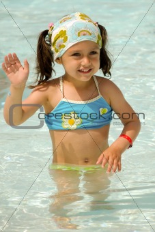 Child waving in pool