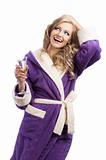 blond hoody girl in bathrobe drinking champagne, she looks up an
