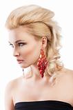 red earring on cute blond girl, she is turned of three quarters