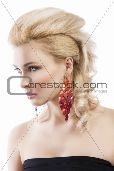 red earring on cute blond girl, she is turned of three quarters