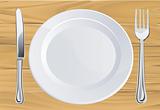 Plate and cutlery on wooden table