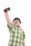 boy holding up cellular phone and smiling