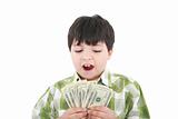 A smiling little boy is counting money - on white background 