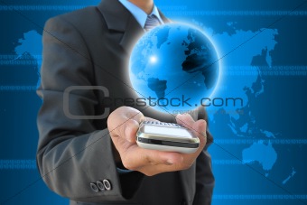 businessman hand holding mobile phone and world