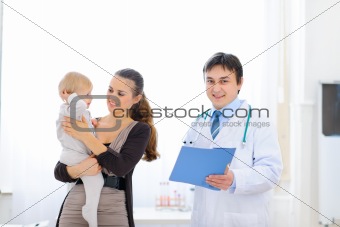 Mother and baby on examination at pediatricians cabinet
