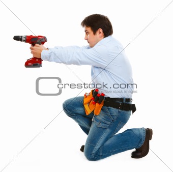 Construction worker using electric screwdriver as a gun

