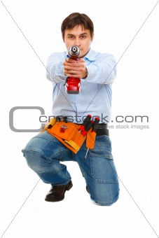 Construction worker using pointing drill as a gun in camera
