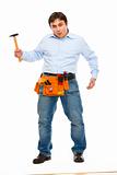 Construction worker showing monkey with hammer. Unskillful tool treatment concept
