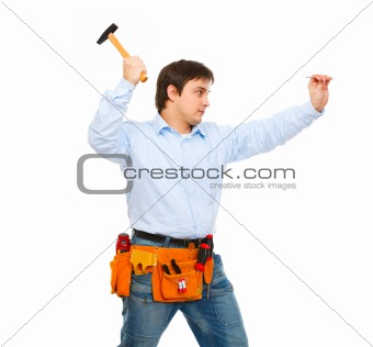 Construction worker hammering nail

