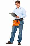 Full length portrait of construction worker with clipboard
