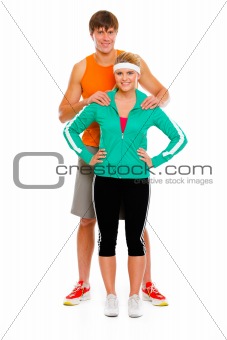 Full length portrait of young man and healthy girl in sportswear isolated on white

