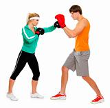Young woman and man in boxing gloves practicing isolated on white
