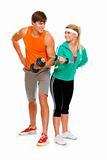 Young man and fitness girl lifting a dumbbell isolated on white
