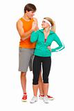 Happy male athlete and fitness young woman handshaking isolated on white
