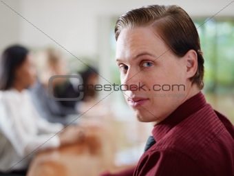 businesspeople talking in meeting room and man smiling