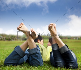 relaxed couple lying on the grass