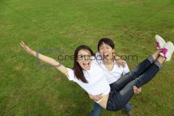 happy asian couple on the grass