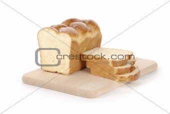 sliced loaf of bread on a cutting board isolated on white