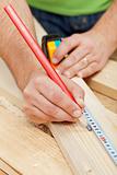 Carpenter or joiner measuring wood