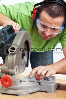 Carpenter or joiner working with power tool