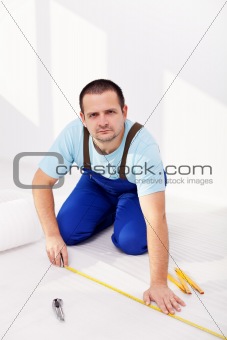Home improvement - man laying isolating foam layer
