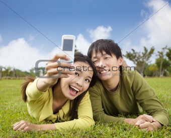 asian couple taking photo by smart mobile phone