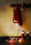 Santa costume hanging on coat hook with christmas lights