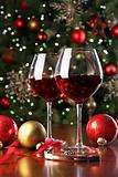 Glasses of red wine in front of Christmas tree
