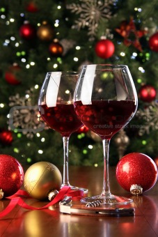 Glasses of red wine in front of Christmas tree