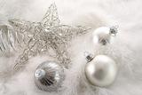 Silver holiday ornaments in feathers