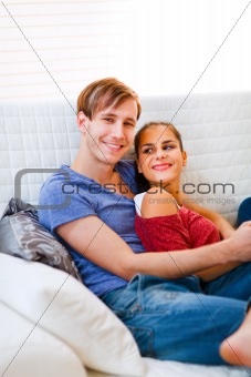 Happy young couple relaxing at home
