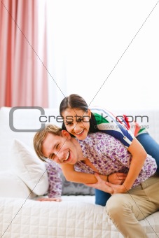 Smiling young couple having fun time at home
