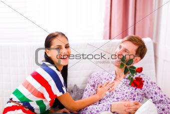 Cheerful young couple having fun time at home
