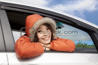 young woman in a car with winter wear