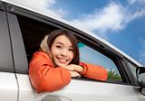happy young asian woman in the car