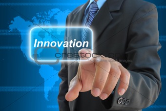businessman hand pushing innovation button on a touch screen interface