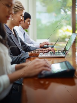 business man and women typing on pc during meeting 