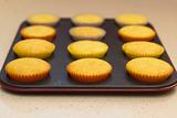 Freshly backed cupcakes on a backing rack. Shallow depth of field