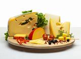 Cheese still life on a wooden round tray