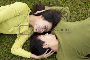 Young asian couple in love on the grass
