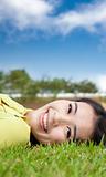 smiling asian young woman on the grass