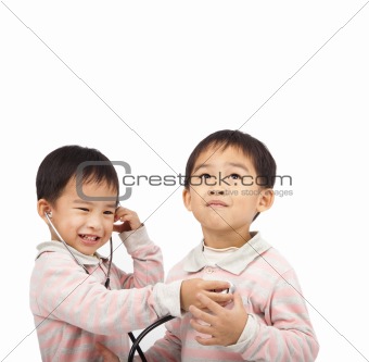 two kids with health examination by stethoscope