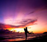Silhouette of happy  couple embracing on the beach