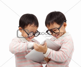 two happy kids using touch pad computer  and isolated on white