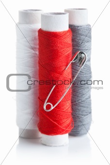 three skein of thread with pin
