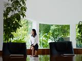 businesswoman contemplating out of window in meeting room