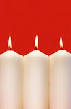 Three white holidays candles 