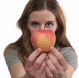 The nice girl holds a tasty apple in hands