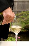 Groom Pouring White Wine