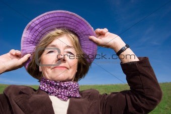 Happy mature woman on the meadow